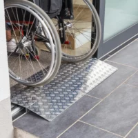 Ein Rollstuhl auf einer Schwellenbrücke an einer Tür